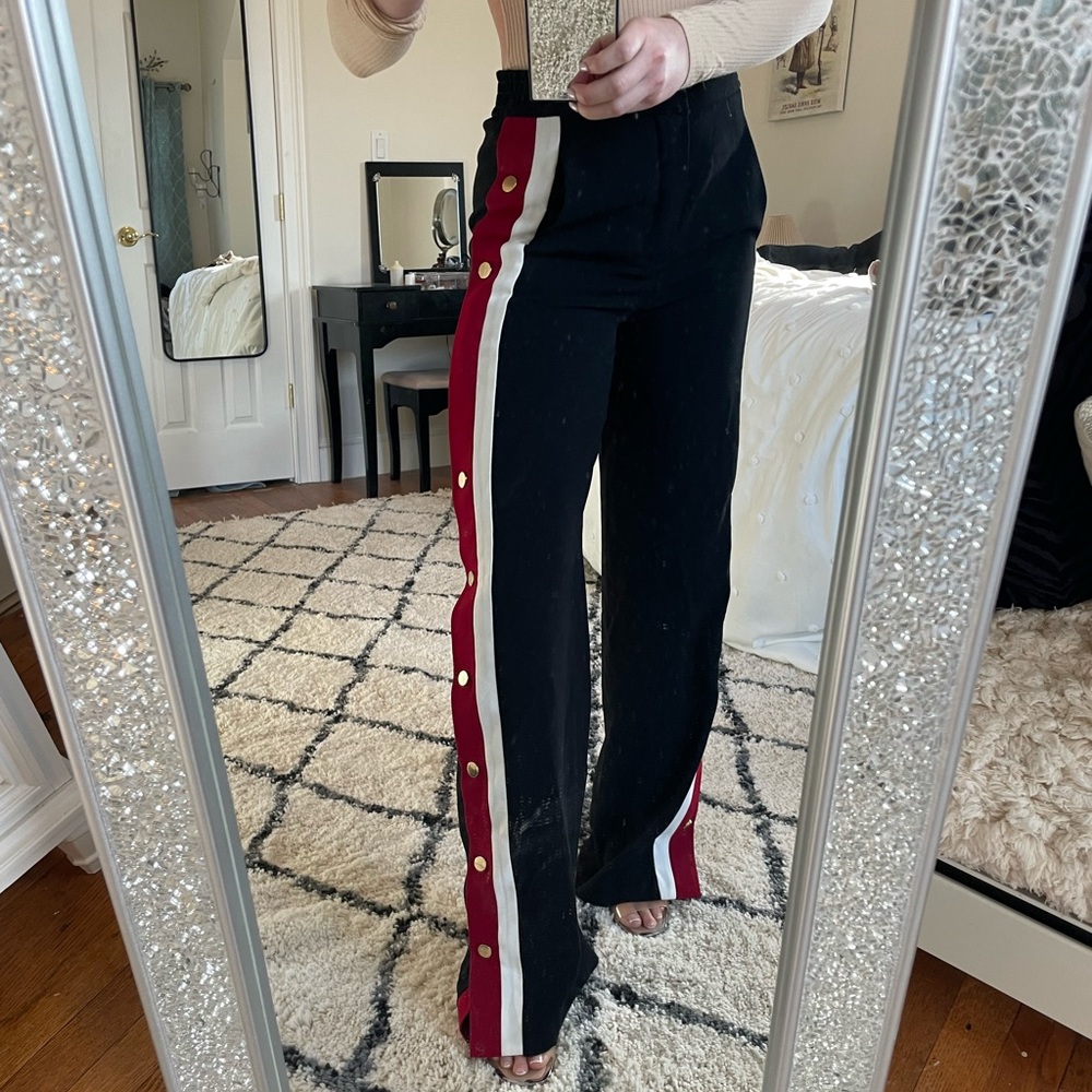 Black Zara trousers with a red and white stripe down each leg. Gold buttons.